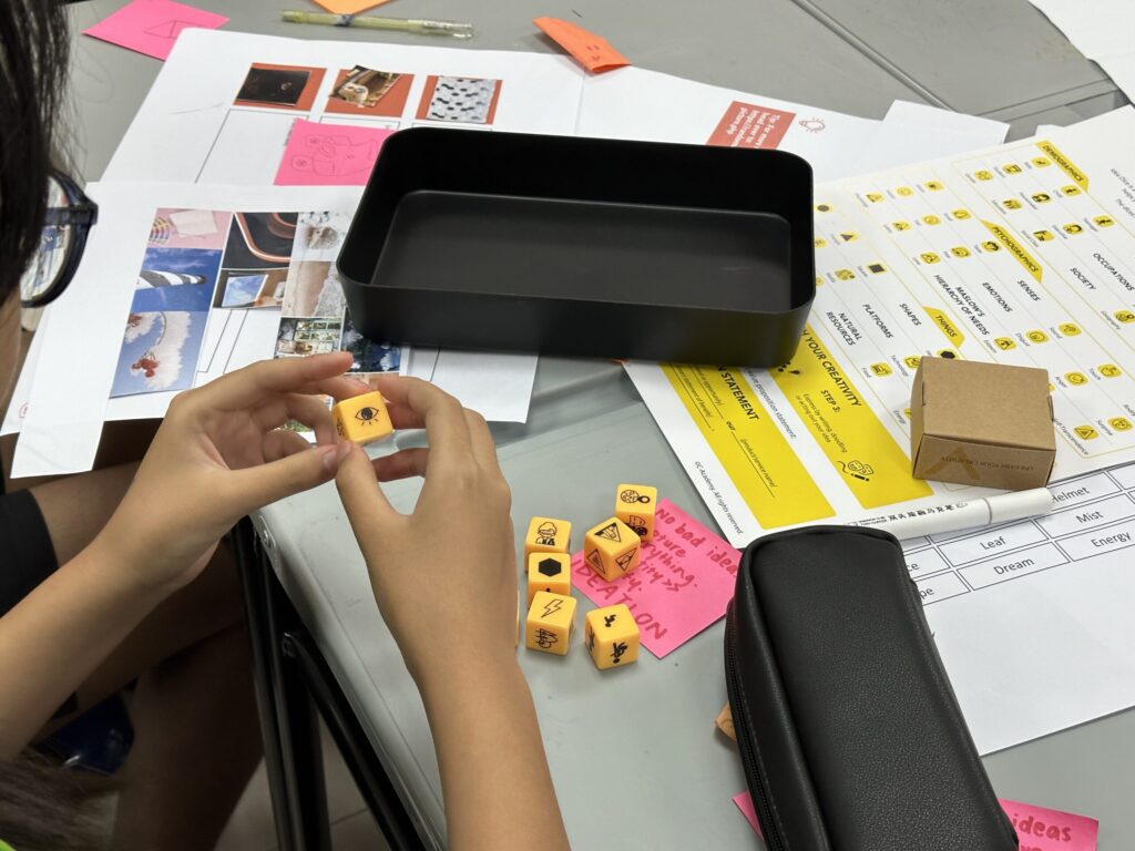 Participants engaging in ideation during a design thinking workshop, using Idea Dice as part of the EDIT design thinking framework
